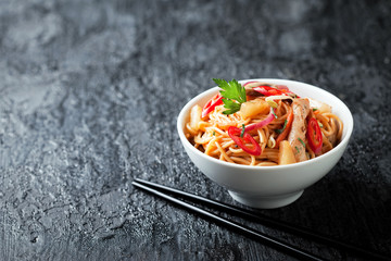 Noodles with vegetables, chicken and pineapple in sweet and sour sauce, selective focus