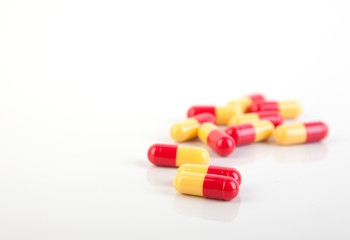 Macro of pills red orange  isolated on white background photo