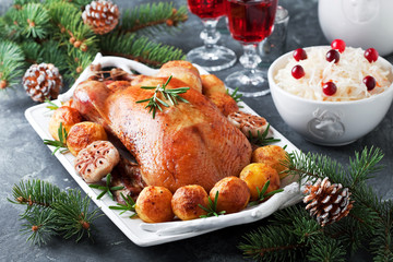 Fototapeta na wymiar Christmas roast duck with baked potatoes, selective focus