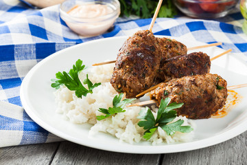 Barbecued kofta with rice on a plate