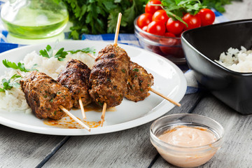 Barbecued kofta with rice on a plate