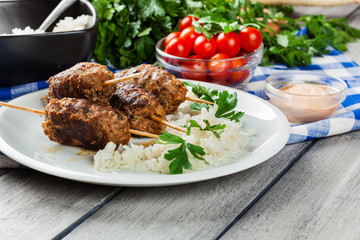 Barbecued kofta with rice on a plate
