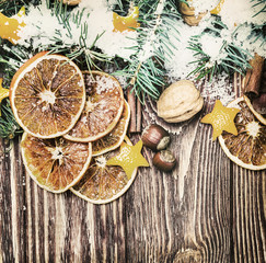 dried oranges with nuts and fir branches