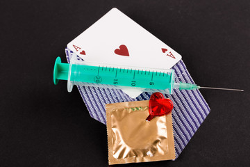 Syringe and playing cards as a vice.