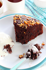 piece of chocolate cake with walnuts served with yogurt