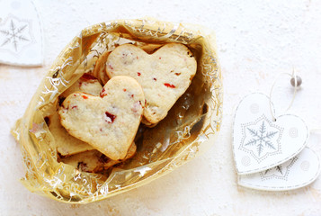 cookies in the heart shaped in a golden bag on a white backgroun