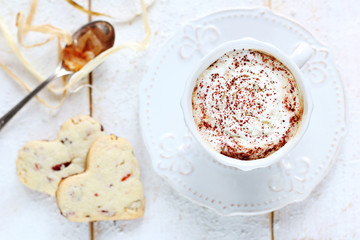 cup of coffee with cream on a white background