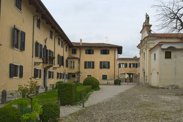 Fototapeta na wymiar Ancient houses and the church of the Strassoldo's castle, Friuli, Italy 