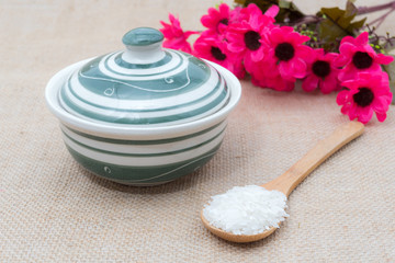 Rice in bowl with spoon on old wooden table