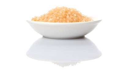 Brown sugar in white bowl over white background