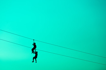 silhouette men hanging Cable cord.