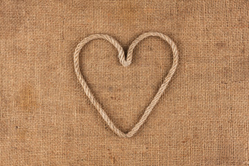 Conceptual image of the heart made in rope lying on sackcloth