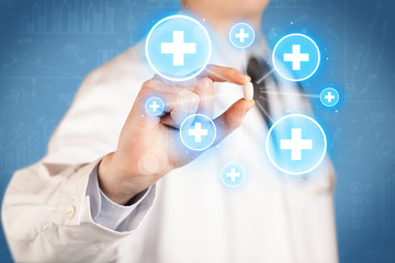 A doctor showing a pill with crosses