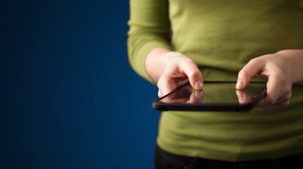 Close up of hand holding digital touchpad tablet device