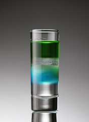 alcoholic cocktail in a glass (arrow)