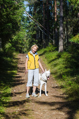 Woman with a dog on a walk in the park