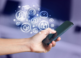 Hand holding smartphone with mobile app choices