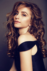 Naklejka premium beautiful brunette woman with bijou, wears elegant black dress