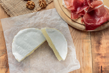 Camembert on old rustic wooden table
