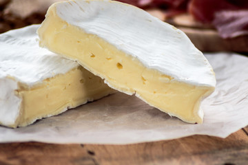 Camembert on old rustic wooden table