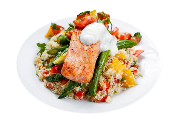 Pan fried Salmon with tender asparagus, courgette served on couscous mixed with sweet tomato, yellow pepper, with greek yogurt, isolated on white