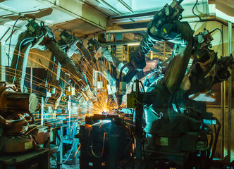 Obraz na płótnie Canvas Team Robot welding movement Industrial automotive part in factory