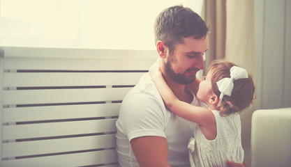 happy family child baby girl in arms of his father at home © JenkoAtaman