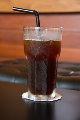 Delicious ice coffee americano on wood table.