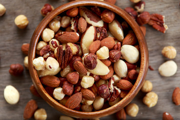 mix nuts in wooden bowls on wooden table