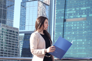 Businesswoman at skyscraper background