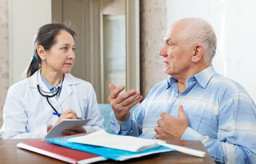 senior man  complaining to serious doctor