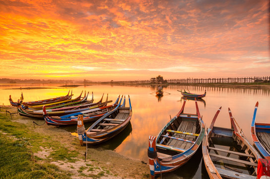 Wooden boat in Ubein Bridge at sunrise, Mandalay, Myanmar (World longest wooden bridge)