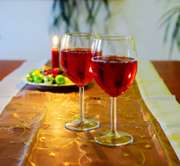 Wine glasses with red wine and christmas decoration