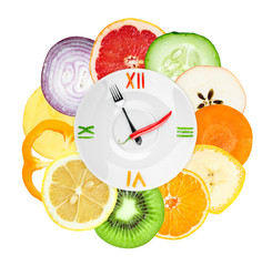 Food clock with  sliced vegetables and fruits