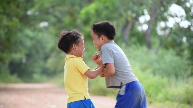 Two boy angry and fighting by punch on the other on the urban road during summer time.