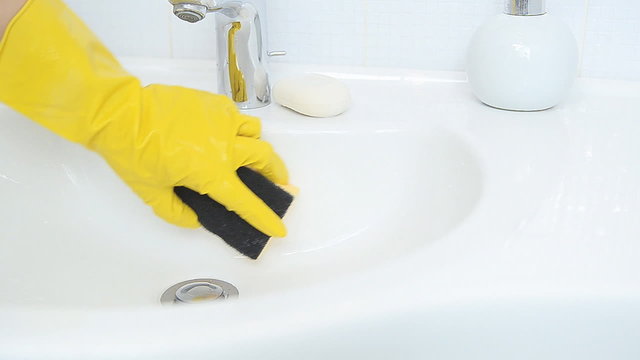 woman doing chores in bathroom at home