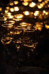 Champagne flautes prepared for a wedding reception with a ray of light