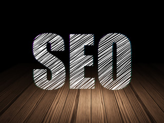 Web development concept: SEO in grunge dark room