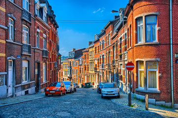 Fototapeta premium Street with red brick houses in Liege, Belgium, Benelux, HDR