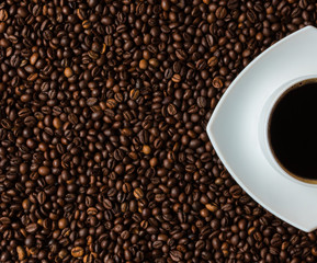Cup of coffee on beans