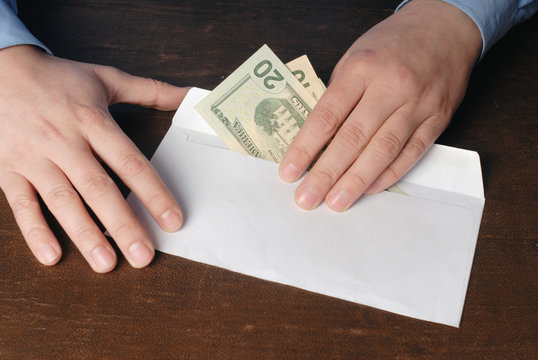 Man taking bribe from envelope