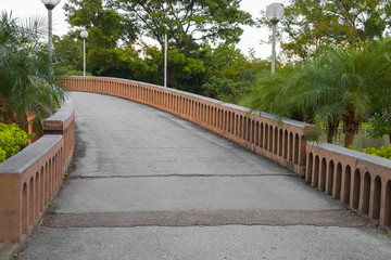 Stone bridge over the stream in a park.