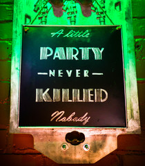 Party sign.  A little party never killed anybody.  Colourful Party sign suggesting one to relax and have fun.