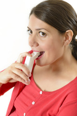 Woman using medicinal throat spray