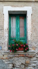 Fototapeta na wymiar Closed Green window in a vintage house