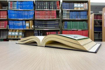 book on desk in library with book column background