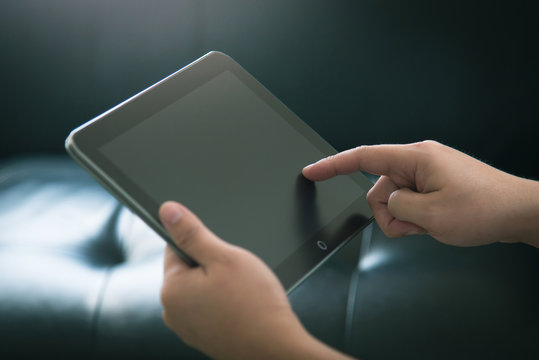 hands touching digital tablet