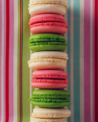 Macaroons on vintage textile background.