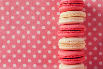 Macaroons on vintage textile background.