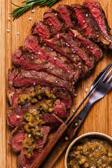 Ribeye steak and mustard sauce with pickles.